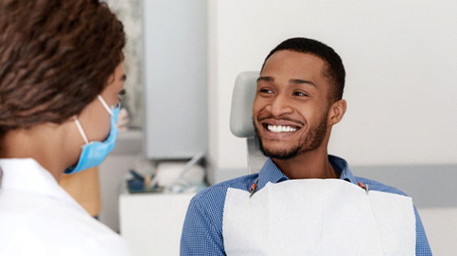 Dental patient smiling at his cosmetic dentist