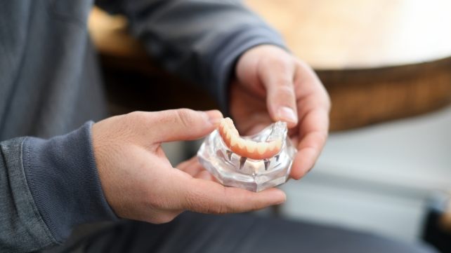 Dentist holding a smile model