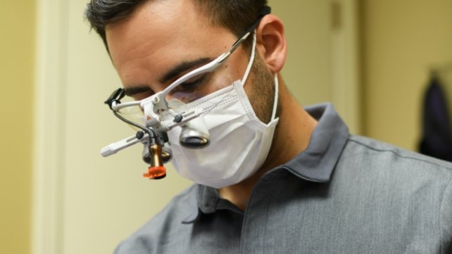 Dentist treating emergency dental patient