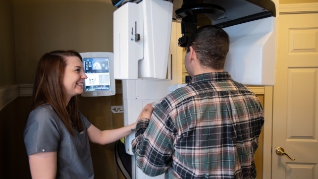 Dental patient receiving 3 D C T cone beam digital x ray scans