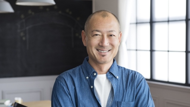 Man in an office smiling