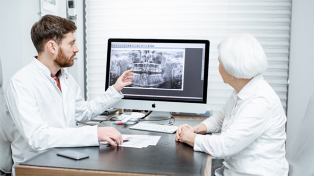 dentist showing a patient their X rays