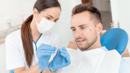 Dental team member and patient discussing payment options for Invisalign treatment