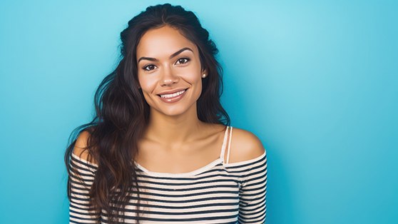 woman smiling against blue background 