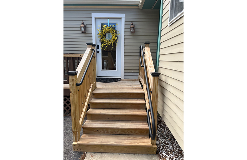 Front view of wooden walkway and front door of Elevate Dental