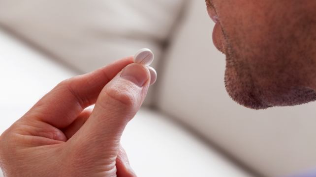 Patient taking a pill for oral conscious dental sedation