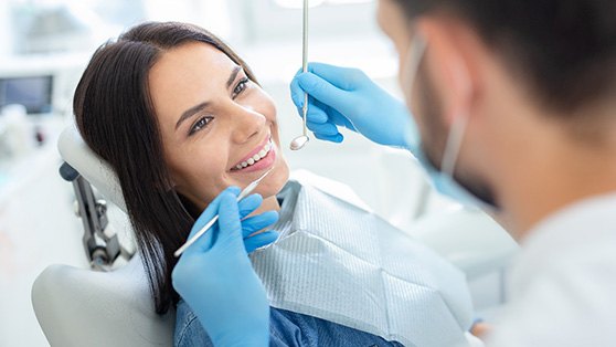 Woman smiling while visiting Colchester cosmetic dentist